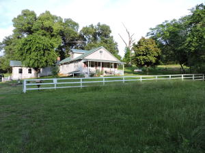 YEAR ROUND CREEK, HORSE FARM and nice 4 bedroom, 3 bath home on 40 beautiful acres, located near Harrison! Large den with vaulted ceilings and wood burning fireplace with insert. Remodeled kitchen with granite counter tops and new side by side refrigerator. New metal roof. Upstairs can be 4th bedroom or rec room. Riding arena, barn and several storage buildings.