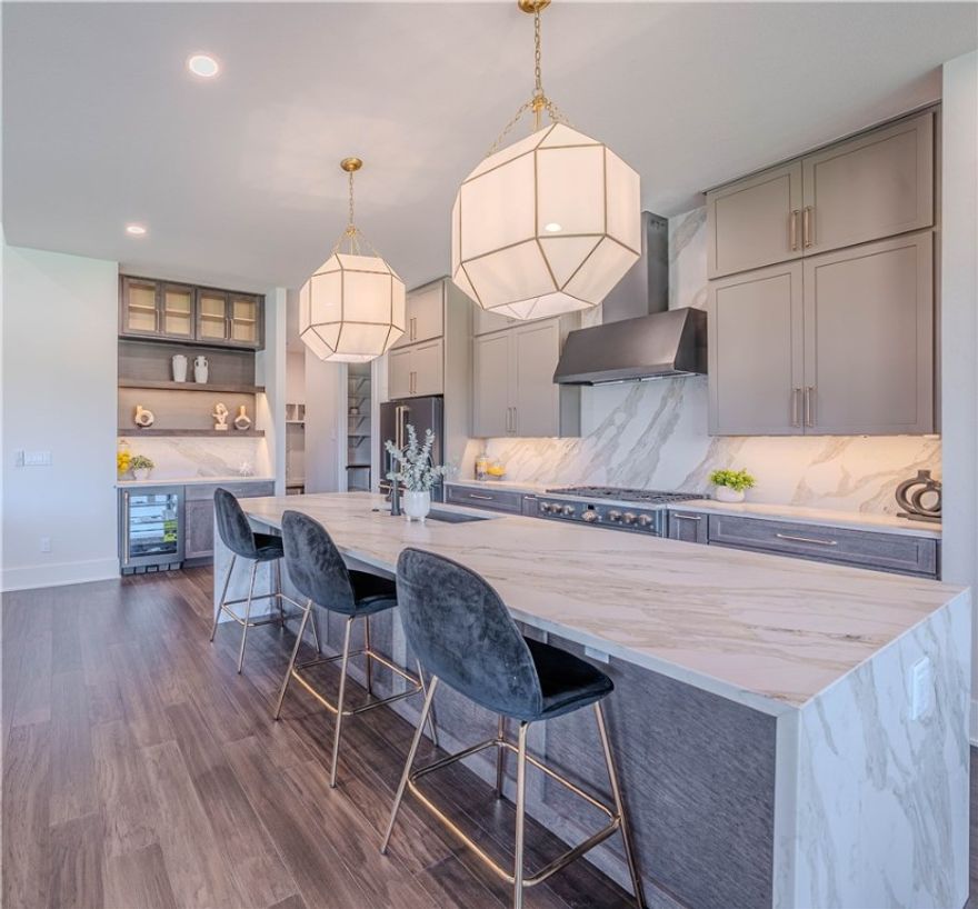 Crafted by the 2024 Parade of Homes Gold Medal-winning builder, The Laney floor plan in the sought-after Aurora community offers the perfect balance of luxury and livability. This stunning two-story home features 5 bedrooms, 4.5 bathrooms, and refined finishes throughout. Designed with modern families in mind, the home showcases a waterfall quartz kitchen island, premium Café appliances, oversized windows, and a seamless indoor-outdoor flow ideal for entertaining. The elegant main suite is a true retreat, complete with a soaking tub and walk-in shower, while additional spaces are thoughtfully planned for both gathering and quiet moments—including areas tailored for children to learn, play, and grow. With stylish interiors, a three-car garage, and placement in the highly rated Bentonville School District, The Laney is where comfort meets convenience in every square foot.