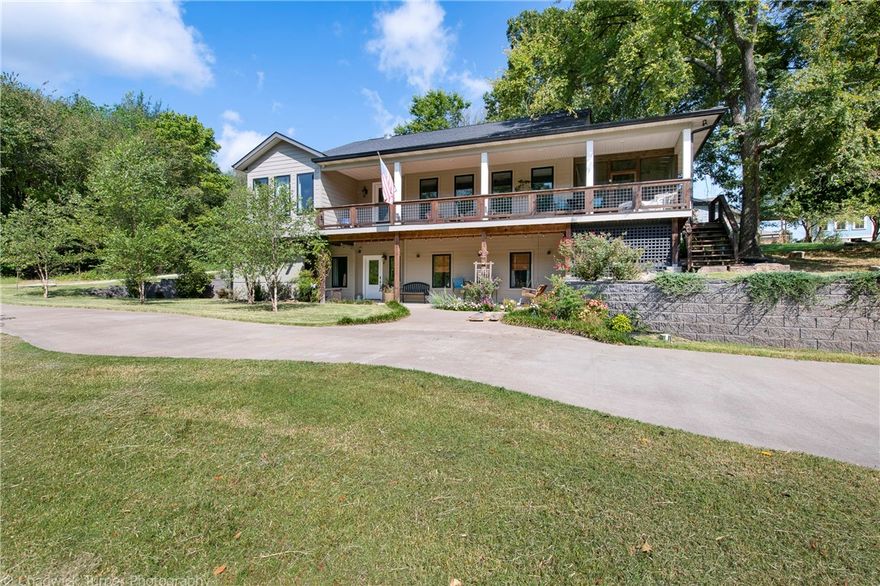 Live feet from the mountain bike trails in downtown Bentonville. This incredible home sits on over half an acre and it feels like a luxury cabin in the woods. Located where Bobo, Choo Choo & Cry Baby come together, this home gives you access to over 80 miles of mountain bike trails. The Crystal Bridges trail head is also right around the corner. The house itself features incredible porches for you to enjoy mother nature, along with a cozy screened in porch with wood burning fireplace. Inside you will find a well appointed kitchen leading to an open living area with a full wall of windows. The kitchen features double ovens, gas cook top and a large walk-in pantry. The owners suite is oversized with a serene view. This home feels great with recycled barn wood accents, museum white walls and great flow. Downstairs you will find 3 bedrooms, 2 that share a bath, each with their own vanity and 1 with a private bath.