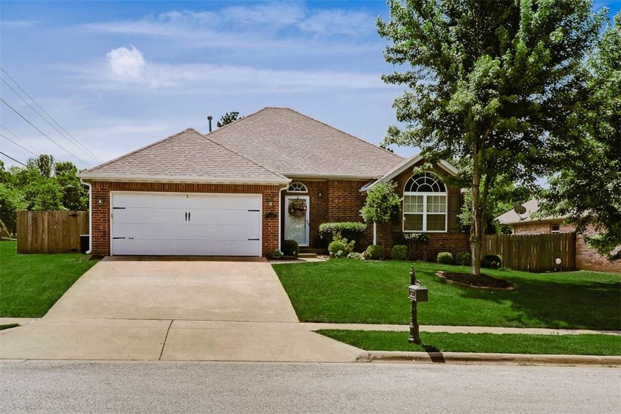 Beautiful home  on a large corner lot, great location close to schools, shopping ,walking trails with easy access to I-49.  This home offers 3BR,2BA ,new carpet in all bedrooms, split floor plan, fresh paint in most rooms, granite tiled counter-tops, island, tumbled marble back splash, custom cabinets, pantry,  walk-in closet, and trey ceiling in master bedroom, jacuzzi tub , walk in shower, 2 sinks in master bath, ,Living Room has gas log fire place and  added recessed lighting. Extended patio with pergola perfect for entertaining. Big back yard with wood privacy fencing.