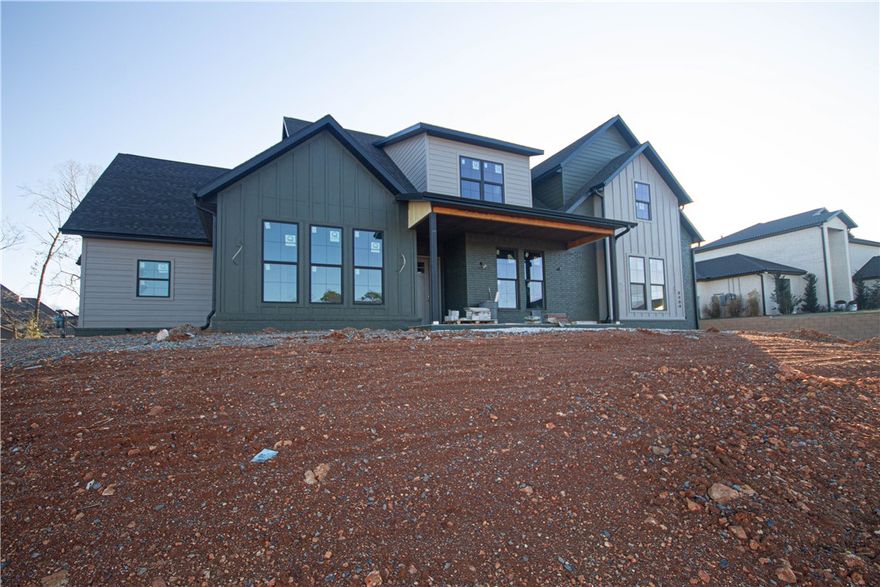 Modern-style home with an exceptional floor plan and two-story living room. White oak hardwood floors, custom-stained pine wood accents & a remarkable linear fireplace. Kitchen is a chef’s dream, featuring a large island with a veggie sink, a professional-grade gas range with 6 burners and a griddle, double ovens, GE Café series appliances, & walk-in pantry with a dry bar. Spacious primary suite with natural light & charming wood accent wall. Spa-like ensuite bathroom offers a soaking tub, double vanities, a massive walk-in tiled shower & an impressive walk-in closet with convenient access to the laundry room. The main level also includes a secondary primary bedroom, a study with French doors & a large mudroom with built-ins for effortless organization. Upstairs, enjoy a versatile bonus room with a wet bar. Step outside to the large covered patio overlooking a beautifully landscaped flat backyard. Additional conveniences-central vacuum system, home audio, security system & garage drop zone with a sink and storage.