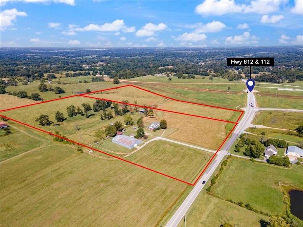 The Value is In The Land.... 33.77 +/- acres of Prime Development Property on the corner of 612 and 112 that is currently zoned Agriculture but is in the Future Land Use Plan as Regional Commercial and has commercially zoned property on its south border. This property is poised to be a prime development location in NWA with the 612 expansion already started and 112 expansion starting their Right-of Way acquisition phase and a future road leading to the airport off of 612. This immaculate property will be the primary road to Tulsa and XNA Airport as roads are completed. Just 5 minutes to 1-49 on 612 and just minutes to Springdale, Cave Springs or Bentonville on 112 you will be in the middle of everything. Sewer runs right through the middle of both parcels, water, gas and electric on site as well. Seller's may require a Life Estate or Delayed Occupancy on +/- 5 acres where that house and shop are. Please reference MLS 1294574.