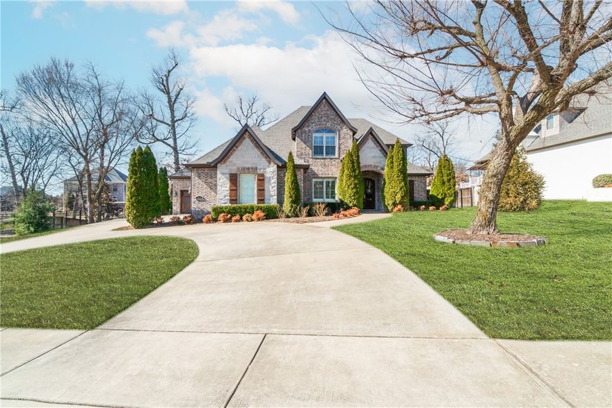 Welcome home to this stunning residence located in the gated Heritage Hills Subdivision.  This 4bdrm/3.5bth home built in 2014 boasts a den with custom built-ins, formal dining room, spacious living room with custom built-ins and fireplace, a heated and cooled four seasons room with a fireplace and an amazing outdoor pergola and patio with built-in bbq grill, griddle and cabinet.  Also added to the outdoor space is custom landscaping in the backyard and iron fencing. Inside you will find a gourmet kitchen with a large island with granite countertops, double oven, gas cooktop, dishwasher, microwave and icemaker.   Upon entering, you will also notice the upscale crown molding, hand scraped hardwood flooring, low e-windows and plantation shutters throughout. Located on a quiet cul-de-sac and a short, convenient drive from I-49, Arkansas Children’s Hospital, Tyson Headquarters and minutes from Fayetteville makes this property hard to ignore. Don’t miss the opportunity to experience all this home has to offer.