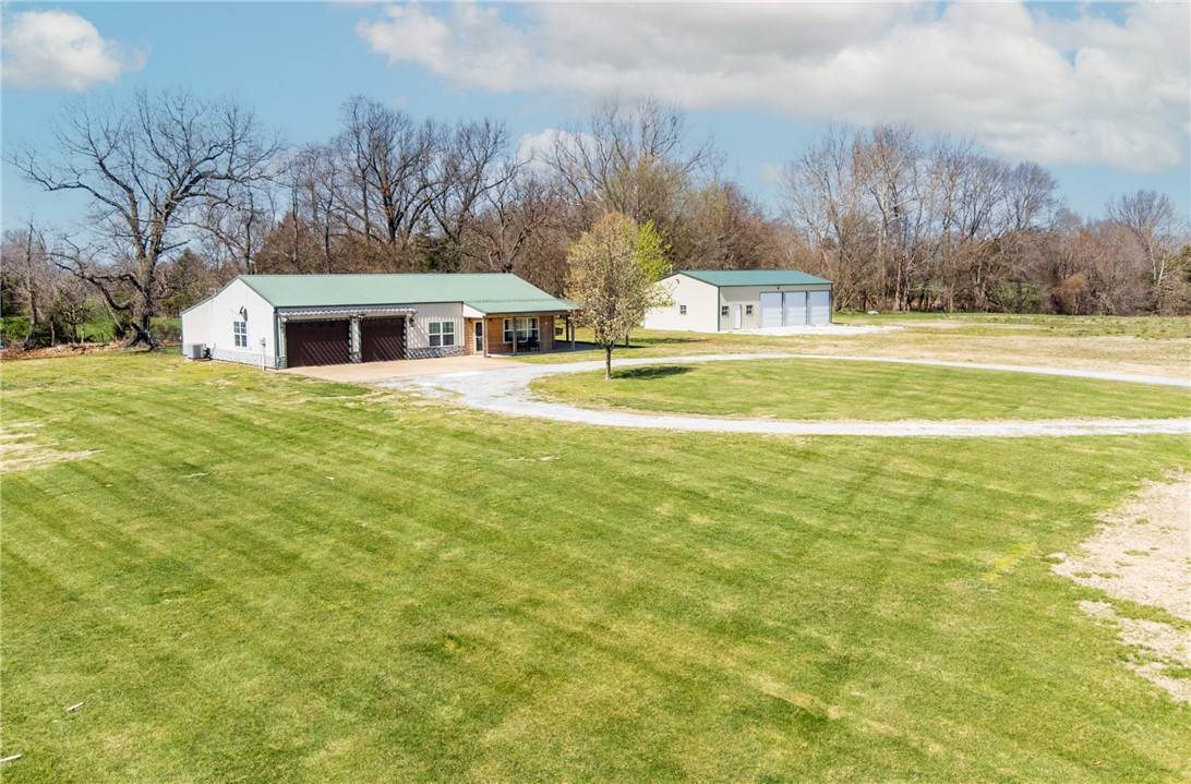Take in country living at its finest with this stunning 3-bedroom, 2-bathroom barndominium on 11.54 acres of nice field in Garfield. Completely remodeled and updated in 2021, this home was equipped with modern major appliances and stylish finishes throughout. The addition of a master suite during the remodel provides additional comfort, featuring a walk-in shower, jacuzzi tub, and a large walk-in closet. The property includes a 2-car attached garage for traditional car parking, along with a 30x50 detached shop complete with three bay doors, propane heat, and closed-cell spray foam insulation, perfect for storage or a workshop. Step outside to enjoy the expansive cleared land, currently utilized as a hay field, offering options for outdoor activities agricultural needs. The large covered porch, complete with an outdoor kitchen completes this countryside home. Schedule a showing today!