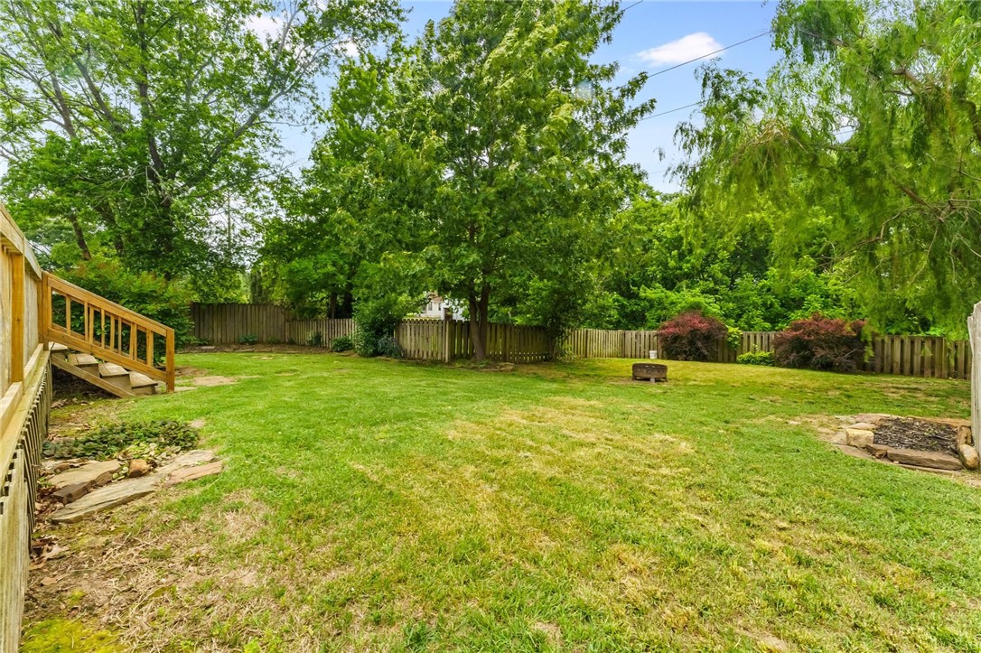 Minutes from Har Ber High, Bernice Young Elementary, and everything the Springdale/Tontitown area has to offer. This well maintained, 3-bed, 2-bath gem is move-in ready and full of charm. Step inside to fresh paint, gorgeous hardwood floors (no carpet anywhere!). Tray ceilings in the living room & owner’s suite. Granite counters in the kitchen w/long peninsula island. The sunroom w/vaulted ceiling overlooks the tranquil backyard that backs up to the tip of Lake Elmdale—no neighbors behind you! Mature landscaping and a massive deck = summer BBQs, morning yoga, & movie nights under the stars. Fridge conveys. Roof & HVAC 2022; Water heater 2023. Don’t miss this one!