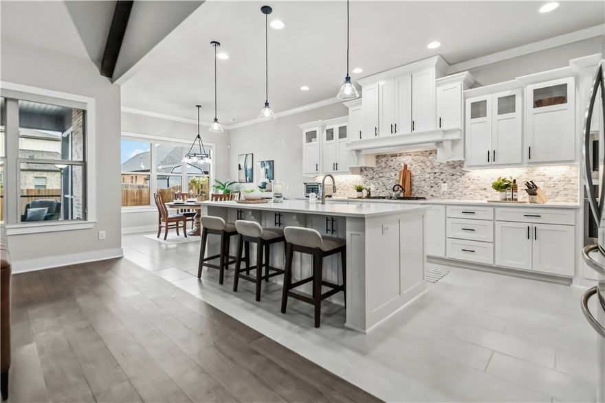 It is hard to believe anyone lives in this home!  Well maintained and immaculate! Somehow it manages to feel both stylish and instantly comfortable—where you kick off your shoes and stay awhile. Inside, plank wood floors and numerous large windows create a warm, happy backdrop for everyday life. With 4 bedrooms plus a flexible office/den, you can finally have that “extra room” everyone wants. The kitchen is truly the heart of the home, with generous cabinetry, counter space, stainless steel appliances,  5-burner gas cooktop, pantry and large island. 
The primary suite is tucked away on the main level, along with a second bedroom. Upstairs, two additional bedrooms are ready for family, guests, or whatever life brings next.  And then there’s the  enclosed patio—perfect for morning coffee, evening unwinding, or quiet moments. Warm, welcoming, and completely move-in ready, this is the kind of home where memories happen naturally.  Bonus:Centrally located and only 15 minutes to Walmart Corporate or Tyson Headquarters.