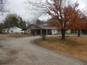 Great potential for a nice large home with a shop and lots of hardwood. Needs updating but had second lot and big separate metal shop. Central heat and a/c with extra lot, pellet FP insert, newer cabinets in kitchen and bath. Lots of character for someone with vision.