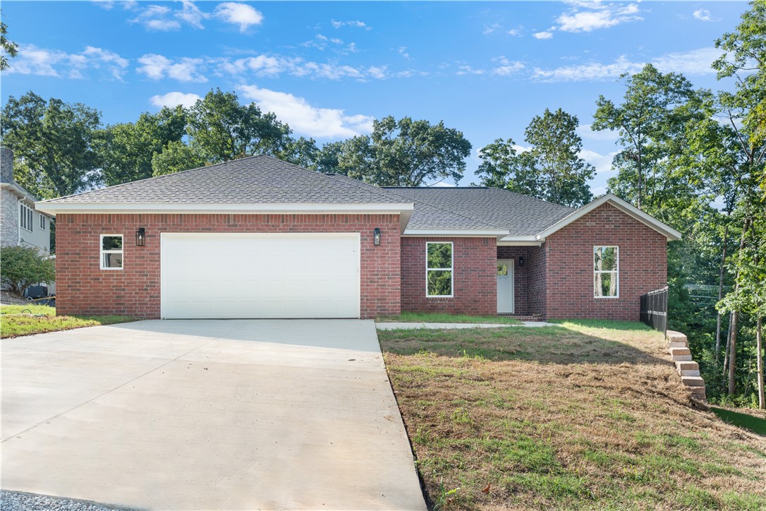 Enjoy comfort and style with this new construction 3-bedroom, 2-bathroom modern home with a bonus office, designed for both functionality and style. Enjoy an open-concept living space featuring luxury vinyl plank flooring, oak cabinetry, and quartz countertops that elevate the heart of the home. A walk-in pantry and kitchen island with water and electric add convenience, while the spacious primary suite offers a large walk-in shower, full size stand-alone tub, and generous closet space with a door that leads directly into the laundry room for easy access to your washing and drying needs. Youāll love the covered back porch that extends the length of the home, perfect for relaxing or entertaining. This home strikes the perfect balance between modern design and everyday livability. Close to Kingswood Golf Course, Bella Vista Recreation Center, Eyeball Tunnel, Waterfall Bella Vista, Crystal Cave, and the Lake Windsor Boat Ramp!
