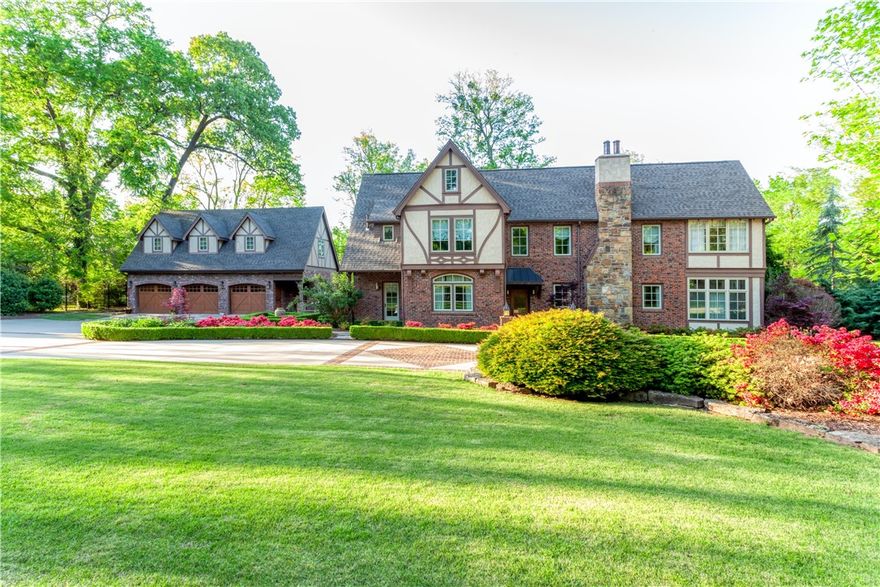 From the road, through the front door, to the backyard, this home will leave you enamored. Located on Fort Smith's Free Ferry Rd, this Tudor style home showcases the beauty and elegance of the 1920's with modern updates such as a gourmet kitchen, Venetian Plaster covered walls throughout, hand carved sinks and mantlepiece, granite countertops, Travertine Tile, new 3 car garage with extra-large bonus room with bathroom and new pool house with ice maker, beverage refrigerator, changing room and bathroom.