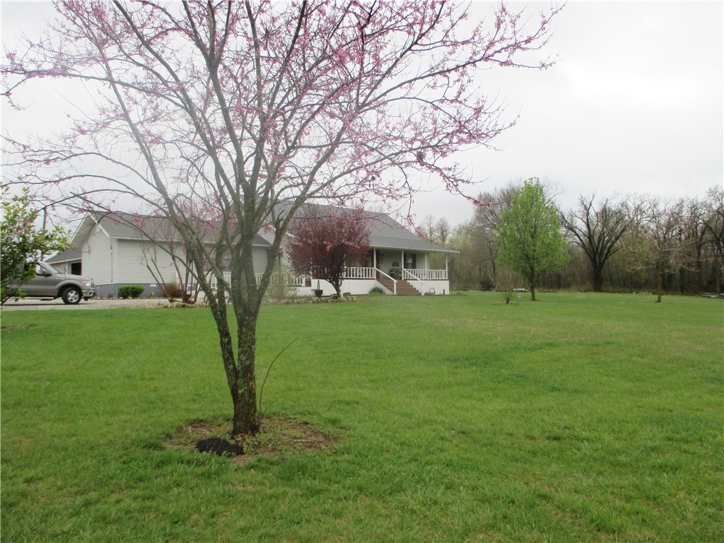 American Dream House, Country living, City convenience! 3 bed/3 full bath, 2727sf, 4.98 cleared acres with an old farmhouse. Large Master bedroom, Carport, RV Parking. Propane tanks rented. Extra large 2 car garage. City water and well. Covered porch, patio, Outdoor living! Airport property across the street. Bentonville Schools. Rural Residential. There is a mobile home used for storage that can be moved.