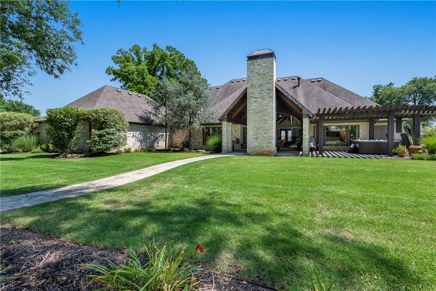 Enjoy unbelievable craftsmanship in the custom one-level home sitting on an estate size lot just outside of downtown Bentonville. This amazing property boasts a 1900sqft RV barn/workshop that can hold all your toys. There are 3 generously sized bedrooms each with ensuite baths plus you have a family room with full surround sound. The great room with its raw wood beams over tongue and groove ceiling flows seamlessly into an incredible outdoor living space. Enjoy alfresco dining by the wood-burning fireplace. Prepare your feast in the outdoor kitchen then cap the night off relaxing in the spa. The grounds are professionally landscaped to give you year-round beauty and privacy. Inside you will fall in love with the chef's kitchen. It features top-of-the-line appliances including a 6 burner gas range w/ a griddle area and double ovens not to mention the cabinet paneled fridge. The elevated primary suite features raised coffered ceiling, a spa like bath and a 30' long walk in closet. Request the YouTube video walk thru.