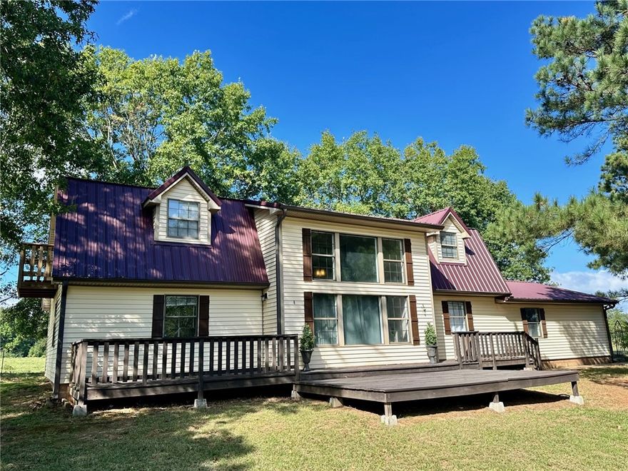 Beautiful updated home on 1 +/-  acre near Lake Ludwig. This charming 3-bedroom, 2-bath, 2,188 sq ft two-story home offers space, comfort, and a peaceful country setting. Situated on a lovely 1-acre lot with mature trees ,this property provides both shade and privacy along Highway 21. The home has been thoughtfully updated throughout, blending modern touches with cozy character. Enjoy spacious living areas, a functional layout, and plenty of natural light. A storm shelter adds peace of mind, while the surrounding trees create a beautiful outdoor backdrop perfect for relaxing or entertaining.