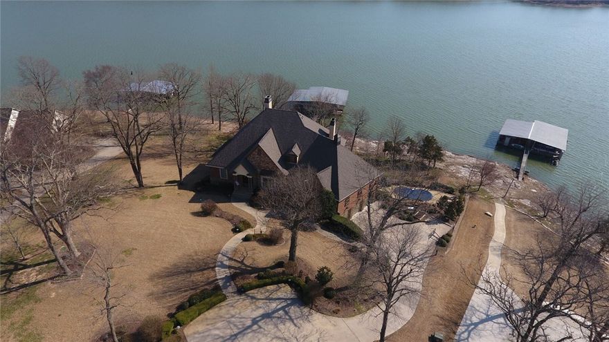 Make your dreams come true! Gated luxury lakefront home. You won't be disappointed in all this fabulous dream home has to offer. 6300 square feet offering pure relaxation for you, your family and friends. 4 stall private boat dock steps from your home w gentle slope. Home features open concept, lake views from most rooms, inground gunite pool, hot tub, a true theatre room complete w bar, an elevator, full decks upper and lower, 2 full kitchens, 6 bathrooms, 2 laundry areas. Welcome to your forever home!!