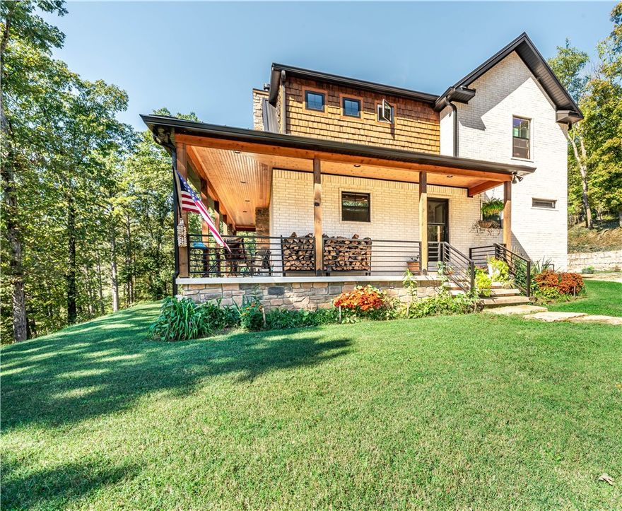 Dazzling modern farmhouse on Big Clifty arm of Beaver Lake and 634 feet of shoreline! From the brick and cedar shake exterior to the light and soaring interior, and out back to the spacious gathering space around the heated in-ground freshwater pool, there is nothing missing from this complete package home. The vaulted great room with wood-burning fireplace invites cozy as well as large gatherings. Scraped Hickory floors complemented with tile in the wet spaces, well-appointed eat-in kitchen, master bedroom suite and combination laundry/pantry/mudroom on main floor. Generous covered porches provide extra room for enjoying the outdoors and for entertaining, with a huge, covered patio area next to the pool. The three-car garage can hold your vehicles and toys, with extra attic storage. Large metal building has 1600 sf of storage/shop/garage space for your toys, plus an 800 sf 2BR/1BA apartment, hot tub and deck, currently used as nightly rental with ~$24,000 annual revenue. Public boat ramp just minutes away!