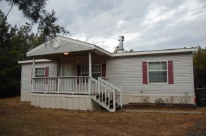 Your own secluded getaway! This 3 bedroom, 2 bathroom treasure is set off the road with mature trees providing a privacy screen between the home and the road. Lots of really nice features! Big, beautiful fireplace in the living room. The master suite has a huge garden tub and separate walk-in shower. Good-sized kitchen and dining area. Covered porch is perfect to enjoy a quiet evening in the country. At this price, it won't last long! Schedule a showing today.