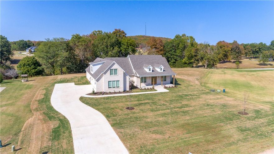 Welcome to this stunning custom built home in the coveted Knolls subdivision! Offering 3,554 sq ft of luxurious living space, this home features 4 spacious bedrooms and 3.5 baths. A large bonus room upstairs includes its own full bath, perfect for guests, entertainment, or a home office. The expansive covered front porch with elegant cedar posts and back patio with a 8ft x 16ft sliding glass door, seamlessly blend indoor and outdoor living! Inside, vaulted ceilings with wood beams and cozy gas fire place create an airy, grand atmosphere! The kitchen is a chef's delight with a large island overlooking the living room, beautiful quartz countertops with matching quartz backsplash, a high-end 48-inch gas range, & huge walk-in pantry with custom shelving. Additional highlights include an open/split layout, oversized 3-car garage, beautiful wood trim details, custom built cabinets, mature trees, and more! The community amenities include a pool, tennis courts, & walking trails, ensuring an active and relaxing lifestyle.