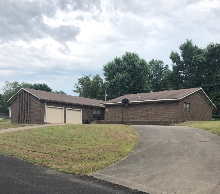 Approximate 2,500 sq.ft. brick home on 2 lots in town. House has 3 bedrooms, 2 baths, a large office(or guest bedroom). The kitchen has an island and the utility room is just off of kitchen for convenience. There is a spacious living room with wood burning fireplace. Nice yard with concrete drive. This home is perfect for a growing family.
