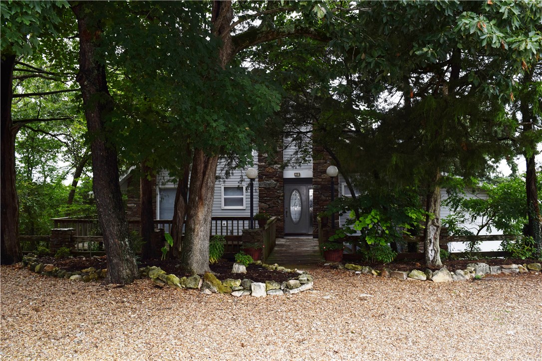 3 level home perched on the bluff, overlooking Table Rock Lake. Decks on all levels, with trees on both sides to frame the fabulous view. Open-concept when entering front, windows + sliders st. across from you, so the view is instantly visible. Kitchen is mostly open to LR + DR. Master on main level, two BD upstairs. Downstairs is large room with wet-bar, plenty of room to entertain, or could be altered for BD or Mother-in-Law area. Plenty of storage down here too. Bath on each level