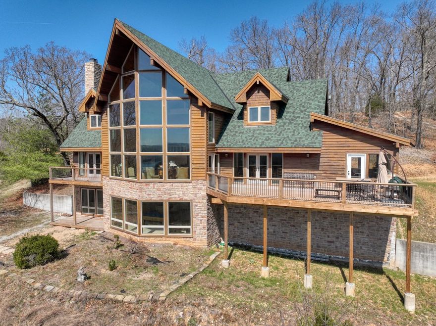 Check out this amazing 48 Acre, 7,530 square foot, Beaver Lake Estate! This enormous property has enough room to keep your family occupied for many years! Three-story, floor to ceiling windows greet you with a gorgeous view of the Ozark hills and Beaver Lake. The main floor contains the kitchen with high end appliances, large dining room, huge living room, the game room/sun room, and the master bedroom. Two bedrooms/baths occupy the large loft level, and the lower level holds a third bedrooms and bath. The lower level also houses the unbelievably impressive dedicated home theater that seats 15 and is modeled after an old western town! Talk about fun! Large decks let you enjoy the outdoors while staring at the lake! The privacy of this estate is already excellent and the property could easily be gated. It’s difficult to find properties of this size in the lake area these days! Starkey Marina, Beaver Dam, the White River, and Eureka Springs are all close by and ready for your next adventure!