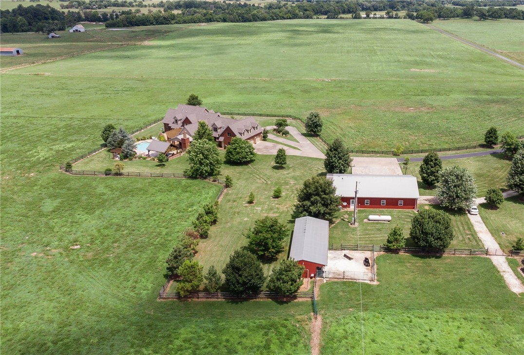 Incredible opportunity to own a piece of paradise! 90.19 acres (3 separate parcels) w/ an estate home, shop, and pole barn. Home features 5,421 heated sq ft which includes 4 bedrooms, 4.5 bathrooms, study, formal dining, open kitchen to living, sitting room, craft room, separate laundry, safe room, and large game room. Other amenities include a butler’s pantry, wide plank oak floors, gourmet kitchen, outdoor shower, in-ground heated pool, cabana, composite decking, outdoor fireplace, tons of built ins and storage, an oversized 3 car garage, and private gated entry. Shop offers 3 separate bays, a private office and full bath. Pole barn offers 3 stalls and a tack room. Property is very versatile and would be perfect for running cattle, owning horses, or development! Please visit www.16812bethelblacktop.com.