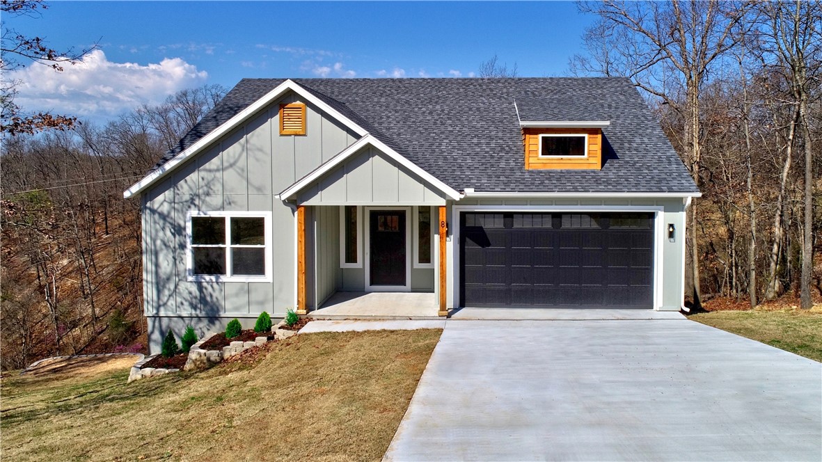 Truly special! One-of-a-kind custom home with a curated interior. Choice, higher-end finishes selected for durability and beauty. Spacious entry leads to a beautifully appointed Great Room/kitchen/dining area with solid oak accents, vaulted ceiling, custom designed fireplace hearth, cabinets and dry bar. Tons of natural light. Primary bedroom features a trey ceiling. Both the primary bath and guest bath feature a 2-sink vanity. Large covered deck to enjoy nature views all year long. PERFECT LOCATION! Nestled on a quiet cul-de-sac, yet only 1 minute by bike to a trail entrance, and only 1 mile to Kingsdale Recreational Center and Golf course. Just 2 miles to Country Club Golf Course, Harps or Allen's Grocery, Riordan Corridor or Town Center restaurants and retail. Adjacent lot included for a total of .88 acres with an acceptable offer. Bentonville schools. Make this wonderful home your gateway to all Northwest Arkansas has to offer. Floorplan uploaded in attachments.