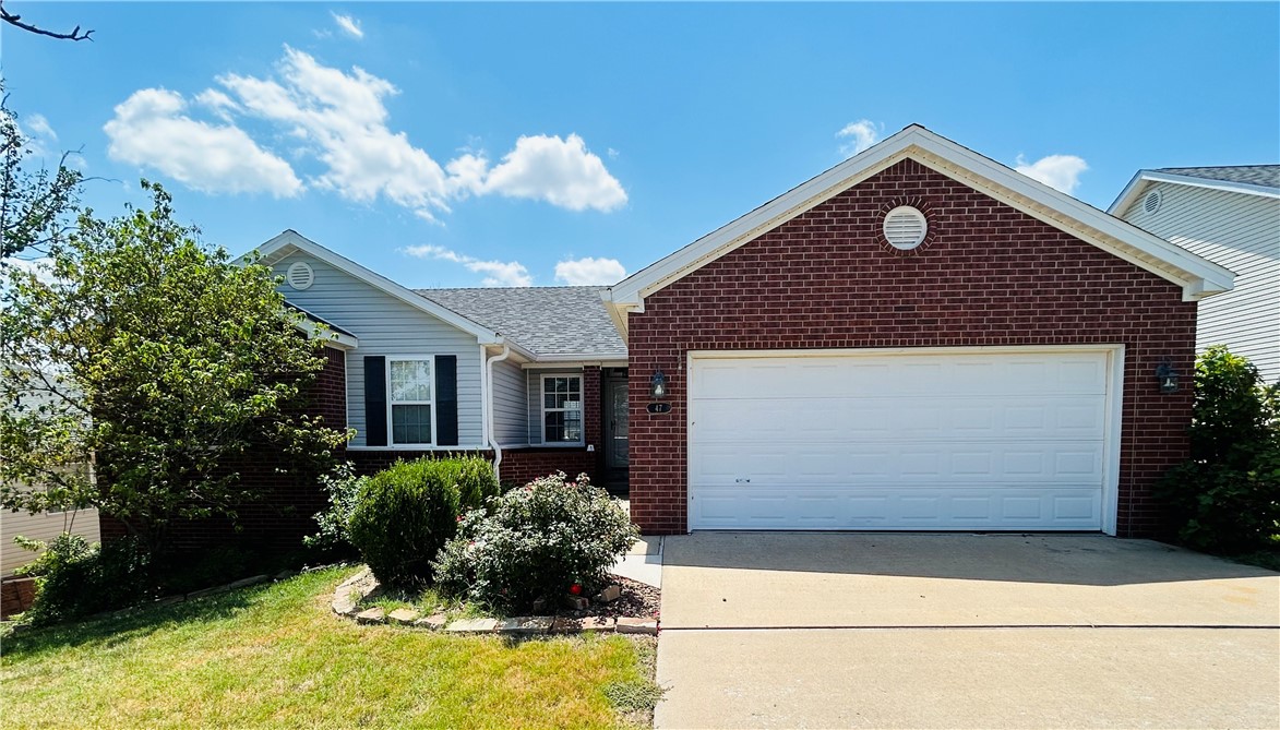 Location, location, location, easy access to Hwy 71 and downtown .This home has 3 bedrooms, 2 baths, 2 car Garage and has had many updates to include beautiful laminate wood flooring, paint, baseboards and a new large kitchen island. Guest bathroom new to include double sink vanity, and updates to primary bath. Primary bath has double sink vanity and double closets. Washer, Dryer and refrigerator provided by owner. Huge deck on back. Fenced in yard. Pet negotiable. Large storage area with concrete pad in basement area, access from under deck. Great trails for walking or biking near the creek. Minus to Slaughter pen Mountain Bike park and I49. Walk to Dog park. No carpet all solid surface flooring.