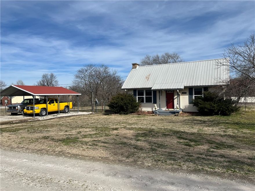 Cozy little country retreat sitting on almost an acre on a short gravel path on the outskirts of town. Fully fenced and plenty of gates for access to all areas of the property.   2 bedrooms, 1 bath with private back porch for the quiet nights of country living. storage shed and workshop are the perfect setup to keep yard tools out of the weather and room for a she shed/man cave for the hobbyists. High efficiency mini-split unit keeps the house comfy while keeping the utilities low.   Generator hook-up for those emergency situations.  Truly a country charmer. Properties like this are hard to find!  Contact an agent today for a showing.