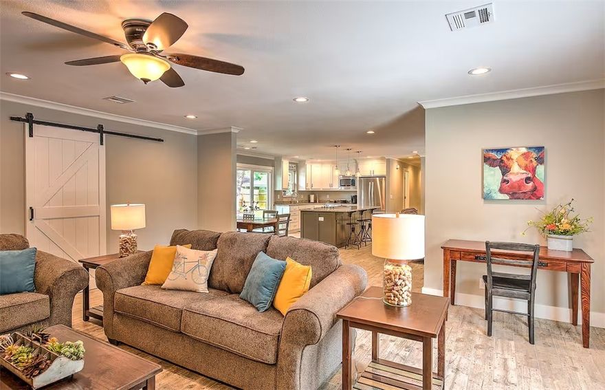 Just a short walk to the Bentonville Square, this one-level stunner combines thoughtful design with laid-back charm. The open layout is warm and welcoming, from the stone fireplace in the family room to the oversized island in the stylish, well-appointed kitchen. Sliding barn doors add flair while revealing a walk-in pantry and a full laundry room. Three spacious bedrooms with custom closets. Both bathrooms are beautifully remodeled with a spa-like design. But the real surprise? The backyard. Shaded, private, low-maintenance—with lush lawn, winding paths, mature trees, and a patio built for star-filled evenings and sunny brunches. There's a secure shed for bikes and gear. Refrigerator, W/D all stay. Furnishings are negotiable. This home is a Top 1% Airbnb Rental in the US. Whether purchased as a new family home or optimizing on a proven investment property, this is a rare blend of comfort, location, and single-level living in the heart of Bentonville.