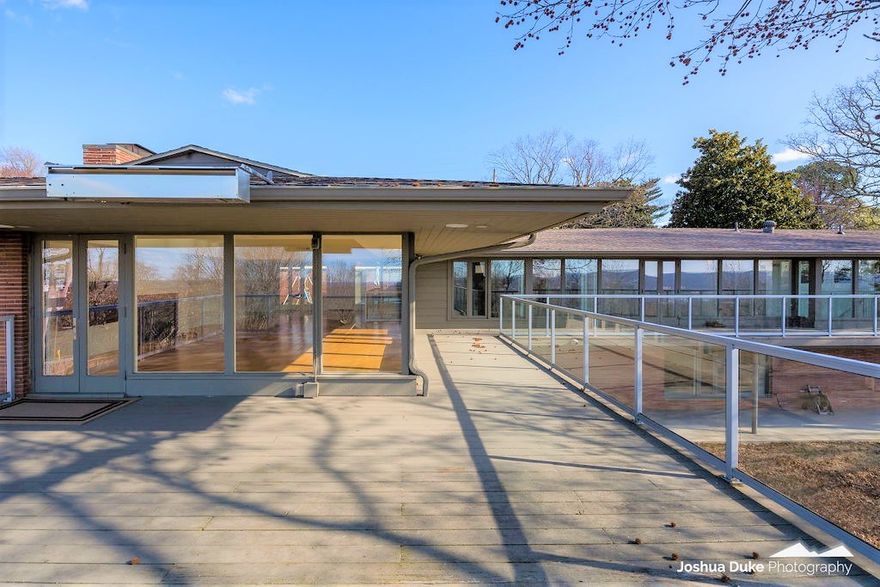 A rare home with expansive views of Old Main & remarkable sunsets. This historic Mt. Sequoyah home on 1.05 acres, originally designed by internationally acclaimed architect Edward Durell Stone, was completely remodeled in 2015 by Tim McMahon. Fabulous layout for intimate & grand events. Main level has living quarters wing w/ amazing master suite, 2 additional bedrooms & full bathroom. Also a second master suite that’s split from main living quarters to offer space & privacy. Main living area includes a beautifully appointed Living Room, 1/2 bath, gourmet kitchen, bar area, hearth & office that allows for open concept living. Huge walk-in pantry w/ full size fridge.  Every room has a view to the west offering the perfect backdrop to this gorgeous space. The natural light in this home is exceptional. The downstairs living space includes 3 living areas, 2 bedrooms, 2 bathrooms, large laundry, safe room & 2 generous sized storage rooms. Basketball goal installed in the early 90s for UA’s basketball coach Eddie Sutton.