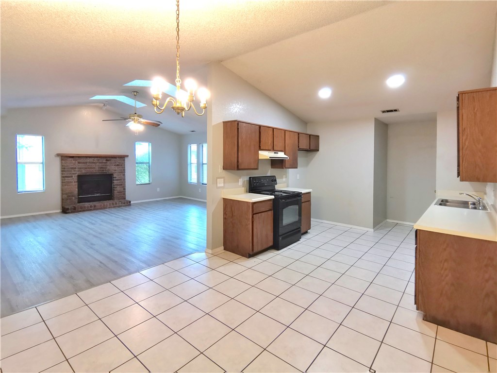 Available Immediately. Discover the perfect blend of comfort and convenience in this spacious 4-bedroom, 2-bathroom duplex. Ideally situated between W Olive St and W Walnut St, this home features an open living area filled with natural light from skylights, a cozy wood-burning fireplace, and sleek laminate flooring throughout. The kitchen is fully equipped with essential appliances, including an oven, dishwasher, vent hood, and in-unit washer and dryer for added ease. With generous space and a functional layout, this centrally located gem offers easy access to all that Rogers has to offer. Don't miss your opportunity to call this inviting home yours!