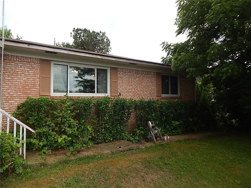 Brick home on quiet street very near hospital, 3 Bedroom, 1 bath, 2 level screened in porch on back, workshop/garage separate, large utility room and eat-in kitchen. New dble pane windows, huge lot. Needs a little updating but lots of potential.