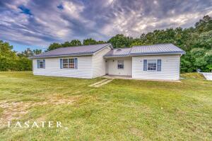 Charming 3BR, 2BA vinyl-sided home with a stylish metal roof. Inside, you'll find a split bedroom layout, updated kitchen cabinets, fresh paint, updated floor coverings, and high ceilings. Situated on a generous 2-acre lot within the esteemed Bergman School District, this property offers room for personalization with just a few finishing touches. Make it your own and enjoy the space and potential this home has to offer. Bonus finished space inside the shed for your hobbies or projects! Agents, see Agent Remarks.