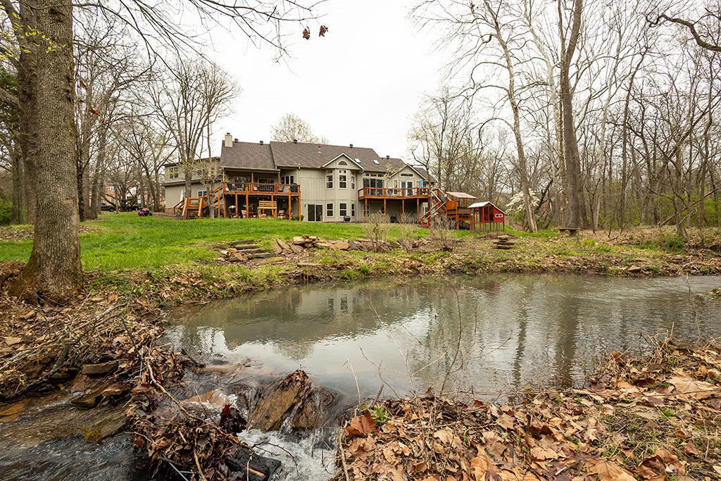 Spring is right around the corner and let me tell you, this house on 1.5 peaceful acres is just MADE for Spring. Whether it's the all-season creek flowing out back or the in-ground trampoline, the fire pit or the many decks and patios, the lush landscaping or the old-growth trees, your life outdoors here has it all and then some. Inside the home you will find an open layout flowing from the family room to the kitchen, the dining and 2nd living room, all while maintaining well-defined separation from one room to the next. The kitchen is spacious, the family room cozy, the fireplaces are multiple and the sun room sunny. The huge primary suite is on the main level, with three guest beds down and one more, or a bonus room, up. Laundry rooms on the main and lower levels (both W/D sets convey), and more storage than you can imagine. Plus a newer roof and HVAC. Even with all that, you are still just minutes from town. Call today to see what your new your new springtime could look like. Agent related to seller.