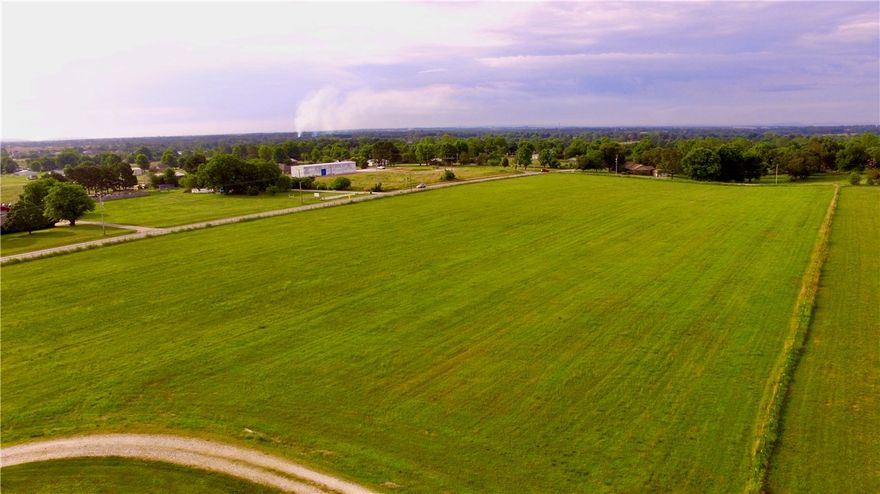 This 11+/- acre property will be sought after for many years as it's located at the corner of Highway 112 and Carrie Smith Ln. Yes that's right no need to take side roads to access this property, it's located conveniently near the entrance and exits ramps of Highway 612. Currently the proposed future plan of the bypass is to turn south and intersect 412 near Tontitown . With very few and or limited exit ramps along the highway this property will have some of the best visibility and highway access of any property now or in the future. There are also several amenities on the land that make it even more sought after as in rural water, and natural gas. The topography is made up of about 11+/- acres of primarily level pasture.