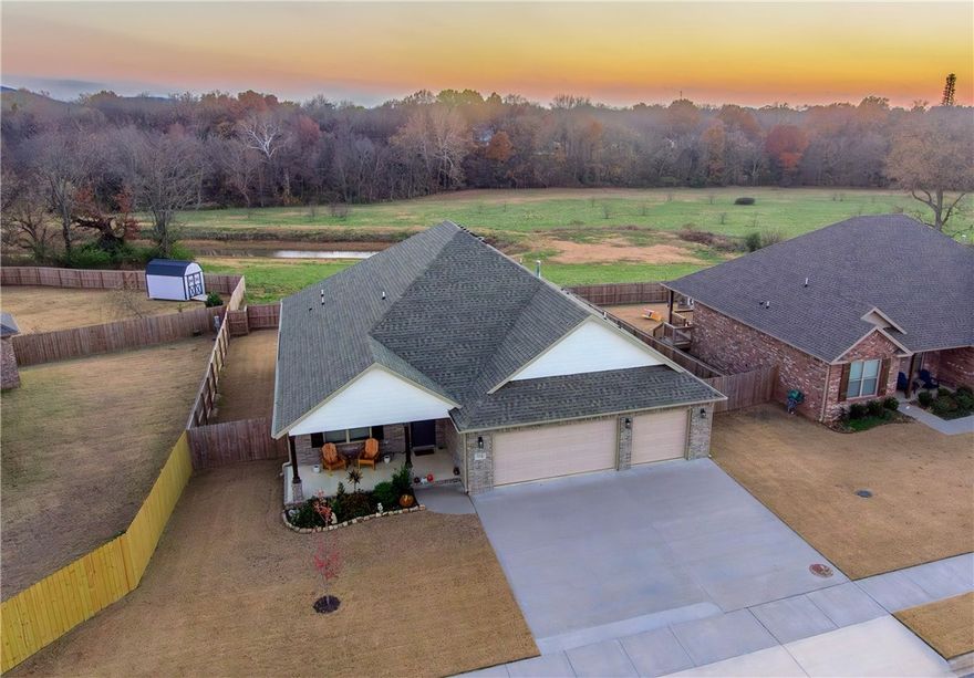 Like new brick home with stunning views from the oversized back deck!  Home features 4 spacious bedrooms, 2 full baths, a 3 car garage, large deck overlooking dedicated green space, fully fenced in yard, open/split layout, big kitchen with island overlooking the living room, gas fireplace, large primary suite with tiled walk in shower and electric fireplace, beautiful stained cabinets throughout, durable wood look tile,  upgraded gas range, and so much more!  Walk to the nearby Creekside Park and enjoy the paved walking trails, basketball courts, multiple playgrounds, pickleball / Tennis courts, ninja course, pavilion, and disc golf!  Only minutes to i-49, schools, shopping, dining, and more!