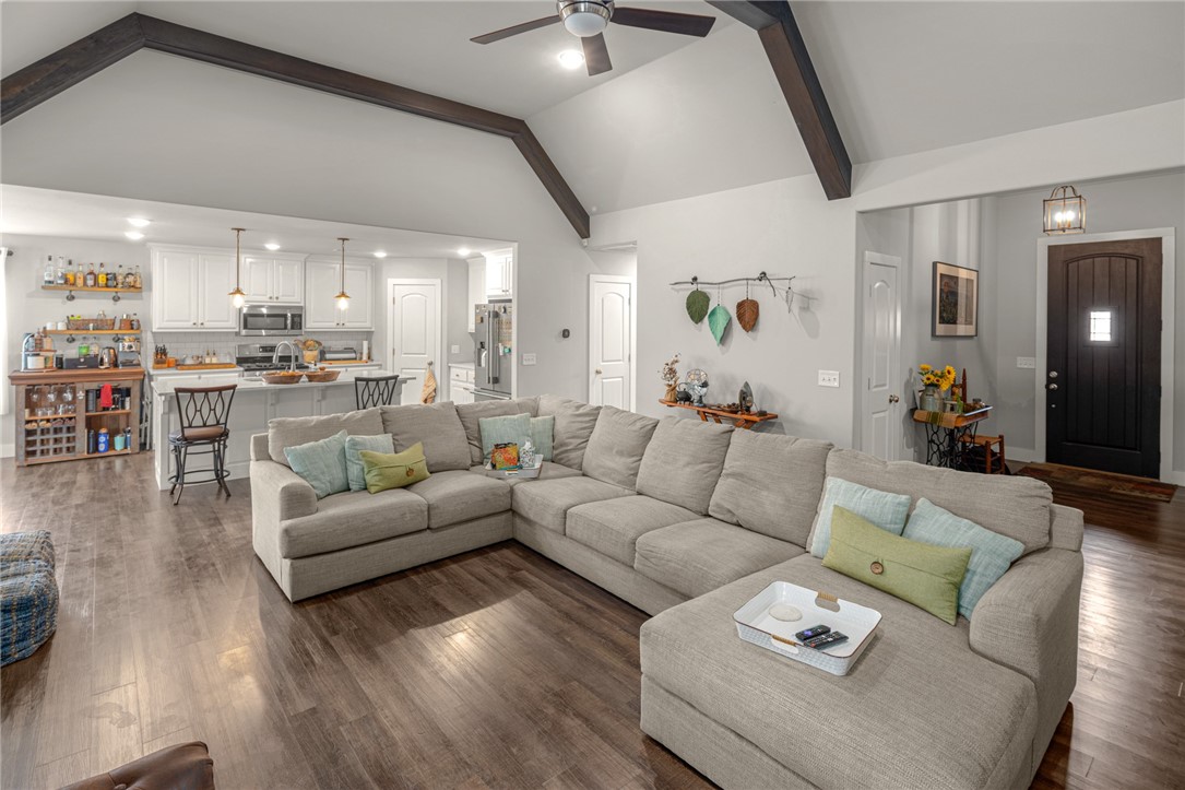 Beautiful modern farmhouse in the heart of Cave Springs! This 3-bedroom, 2-bathroom home features 1,901 sqft of stylish living space with soaring ceilings, wood beams, luxury vinyl plank flooring, and a cozy gas fireplace. The open kitchen includes quartz countertops, a large island, subway tile backsplash, stainless appliances, gas range, and a walk-in pantry. The split floor plan offers a private primary suite with tray ceiling, sliding barn door, double vanity, soaking tub, tiled walk-in shower, and a large walk-in closet. Additional features include a built-in desk, mudroom, and laundry room with custom touches. Enjoy the huge covered deck, storage under the deck, and a spacious privacy-fenced backyard. Zoned for Bentonville Schools and located in a quiet neighborhood with easy access to everything Northwest Arkansas has to offer.