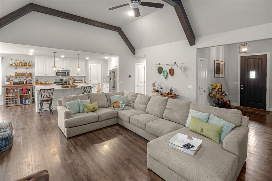 Beautiful modern farmhouse in the heart of Cave Springs! This 3-bedroom, 2-bathroom home features 1,901 sqft of stylish living space with soaring ceilings, wood beams, luxury vinyl plank flooring, and a cozy gas fireplace. The open kitchen includes quartz countertops, a large island, subway tile backsplash, stainless appliances, gas range, and a walk-in pantry. The split floor plan offers a private primary suite with tray ceiling, sliding barn door, double vanity, soaking tub, tiled walk-in shower, and a large walk-in closet. Additional features include a built-in desk, mudroom, and laundry room with custom touches. Enjoy the huge covered deck, storage under the deck, and a spacious privacy-fenced backyard. Zoned for Bentonville Schools and located in a quiet neighborhood with easy access to everything Northwest Arkansas has to offer.