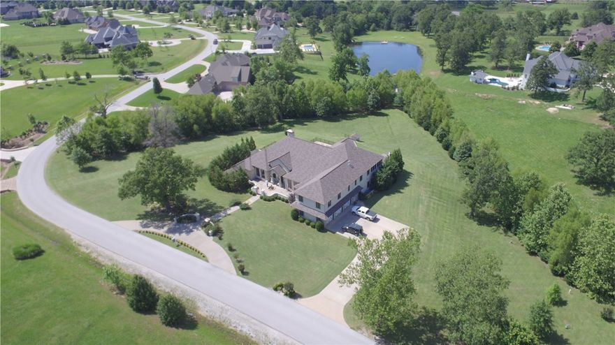 Crafted estate on almost 2 acre lot, boasts a classy design & detailed layout, new wood floor throughout in the formal living rm, dining rm. Floor to ceiling windows, study w/fireplace, new cabinets/paint in gourmet kitchen open to family rm, 2 guest rooms & luxurious master suite w/its own courtyard/ custom fireplace. 2nd level has loft area, grand bonus room, craft room & 2nd master suite w/ 18x18 screened porch. Saltwater pool, stone fireplace, outdoor kitchen w/pizza oven. Oh, did we mention elevator?