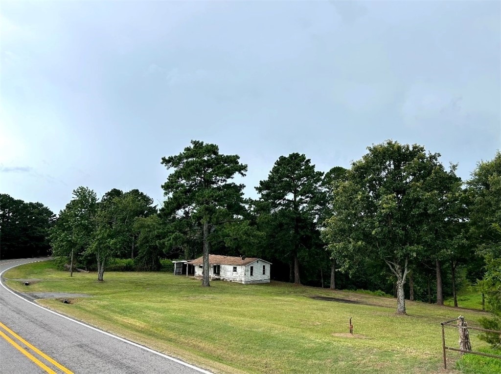 Beautiful, Beautiful 1 acre lot with very old home. Possibly a good carpenter could restore the structure. Listing price determined by lot value only. SOLD AS IS.