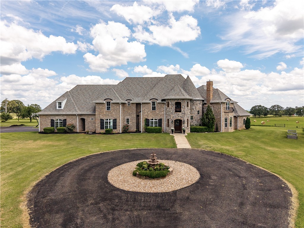 Stunning Custom Estate with Panoramic Views on 5 Acres!
This 7,300 sq ft custom home offers luxury, space, and unforgettable views. Set on 5 acres that feel like 100, it features a resort-style pool (2024) with diving ledge, waterfall, fire bowls, LED lighting, and heater. Inside: 6 bedrooms (2 main-level suites), 5 full baths, 2 half baths, a game room, theater, office, and potential gym. The chefās kitchen includes 2 built-in fridges, large range, and walk-in pantry, all open to the family room. Near the theater, enjoy a bar area and walk-in wine room. The main suite features a double-sided fireplace, soaking tub, dual vanities, and large walk-in closet. Upstairs, find an 800 sq ft bedroom with private bath, and an ensuite with vineyard views. The theater room also includes a storm shelter. Mostly grass, the 5-acre lot is ideal for outdoor living. Relax on the covered porch and take in the breathtaking scenery. Donāt miss this one-of-a-kind property!
