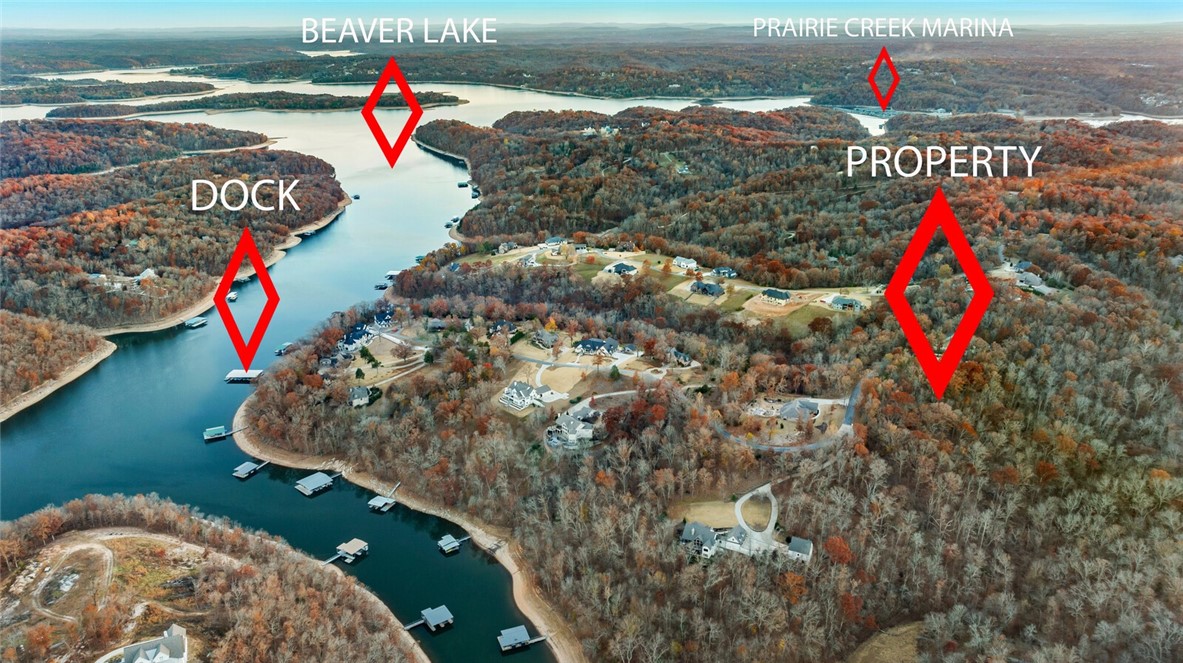 An enchanting, wooded lot nestled within the prestigious Estates of Lakeway. A sprawling 3.10 acres, plus a slip in the community dock which includes a boat lift and locker (both new in 2022)! This is a versatile lot to build on, including a flat area at the front and the possibility for a walkout basement where the terrain begins to slope, with water and electric at the street. Previously perc tested (2020) for a four-bedroom house. Come see this exceptional property and the natural beauty of Beaver Lake! Seller is related to List Agent.