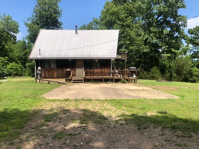 Location, Location, Location! This home is situated on 6.75 acres on Bull Shoals Lake, featuring a walking path to the shore and bordering government land at a lake point. The property is secluded and includes an A-frame cabin western cedar exterior with a metal roof. It offers 3 bedrooms and 2 bathrooms, with a total living space of 1,400 square feet. There’s an unfinished basement that can be used for storage or as a storm shelter. In addition, you'll find outbuildings including a 24x48 pole barn and a 12x30 workshop. Enjoy a 180-degree view of the lake. While the home needs some TLC, it presents an excellent opportunity for a perfect summer getaway or a private residence. It features mini-split systems for both cooling and heating, along with a wood stove and a wood furnace for additional heat sources.