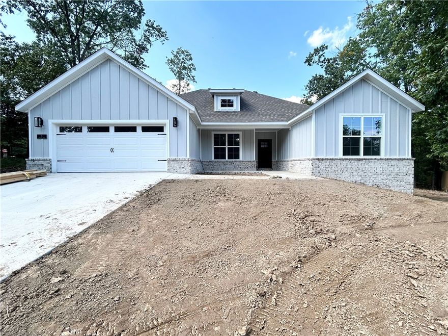 Stunning new construction home on a flat .39 acre lot! Only 1 minute away from Highlands Golf Course and perfectly situated near Lake Loch Lomond, Branchwood, and provides quick access to I-49! Step inside to discover a beautifully designed interior with 3BD's + office, a split floor plan, & high-end modern finishes throughout. The spacious living area showcases vaulted ceilings with elegant beams, creating an inviting atmosphere. The kitchen features sleek 3 cm quartz countertops, a gas range, custom cabinets, and premium black stainless-steel appliances. Retreat to the luxurious primary bath, which boasts a huge walk-in closet, a large custom walk-in tile shower, and a soaking tub. 2 covered patios. As an added bonus, receive $3,500 towards buyer's closing costs when working with the builder’s preferred local lender!