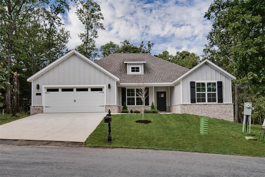 Stunning new construction home on a flat .39 acre lot! Only 1 minute away from Highlands Golf Course and perfectly situated near Lake Loch Lomond, Branchwood, and provides quick access to I-49! Step inside to discover a beautifully designed interior with 3BD's + office, a split floor plan, & high-end modern finishes throughout. The spacious living area showcases vaulted ceilings with elegant beams, creating an inviting atmosphere. The kitchen features sleek 3 cm quartz countertops, a gas range, custom cabinets, and premium black stainless-steel appliances. Retreat to the luxurious primary bath, which boasts a huge walk-in closet, a large custom walk-in tile shower, and a soaking tub. 2 covered patios. As an added bonus, receive $3,500 towards buyer's closing costs when working with the builder’s preferred local lender!