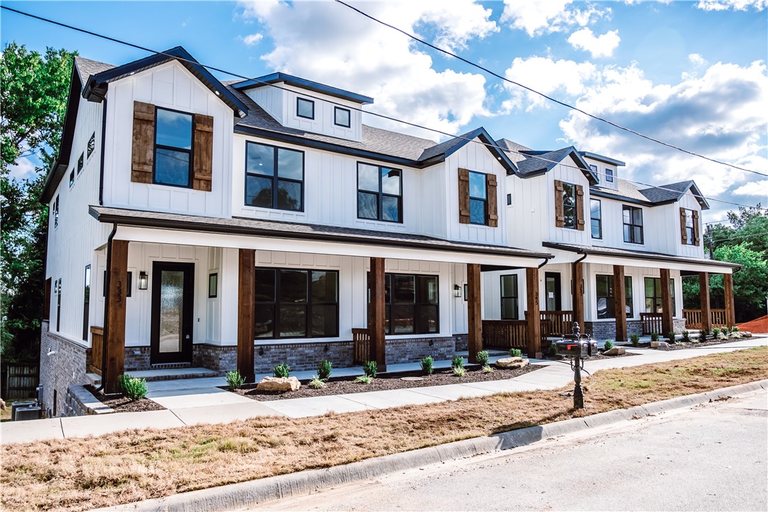 *** Seller is offering a $5000 Buyer's Agent Incentive to be paid upon Closing for any accepted offer that closes prior to June 1, 2021. *** Estimated completion April 2021. New Townhouse within walking distance of downtown Fayetteville, the Square, Dickson St, the Greenway Trail, and the new Public Library just across the street. Gourmet kitchen complete with granite countertops, Frigidaire Pro stainless steel appliances, a large double door refrigerator and a walk-in pantry. Covered outdoor patio with outdoor gas fireplace, a TV hookup and great views of the mountains to the south. There's also a full-width porch on the front of the house. The spacious master bedroom has its own balcony and a dream master bath that has to be seen. There are two more bedrooms, each with their own full bathroom as well. Additional touches include a two-car garage, separate laundry room, Nest thermostats and six different TV/AV connections throughout the home. Townhouse living in convenient downtown location and amenities galore!