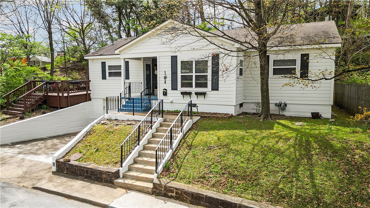 Big price drop on this Wilson Park low maintenance home that is a fully licensed Fayetteville AirBnB! 2 minute walk to Wilson Park, 5 minutes to University of Arkansas and a 7 minute walk to Dickson St. Jump on the bike trail in a 2 minute bike ride and ride to University of Arkansas, Dickson St, Fayetteville Square or all the NWA trails. Location and charm is what this updated home features with original hardwoods in throughout most of the home. A large inviting living space opens to a dining area and an updated modern kitchen with stainless appliances. Two bedrooms at the front of home with one featuring its own locking front door and sliding back door, so you could rent this room separately if needed. Large primary suite sits on the other side of home for privacy. Secluded patio deck is perfect for entertaining or relaxing. Purchase the perfect Wilson Park home fully furnished with a fully transferable Type II AirBnB license with City of Fayetteville, making this a turnkey investment!