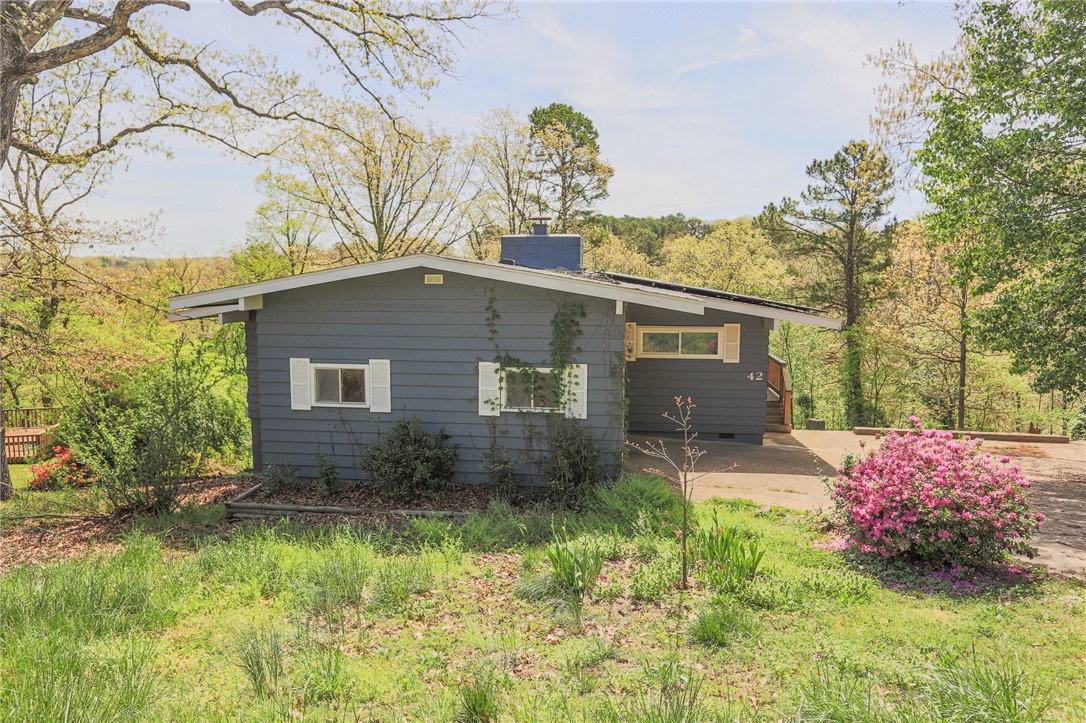 Calling all Mt Bikers. Completely remodeled home with a magnificent view of the Ozarks, The Tunnel Vision Bike Trail is just below the house and only a few feet away from your back door! Home has solar panels which will be a huge bonus for lower utility bills. New wrap around deck, and a second lower deck to enjoy the outdoor views. Completely renovated interior with all new bathrooms, kitchen with quartz counters and stainless appliances. Modern Electric Fireplace flanks the vaulted living room wiith lots of natural light. Hard surface flooring throughout . Refrigerator, and washer/dryer included for tenant use.