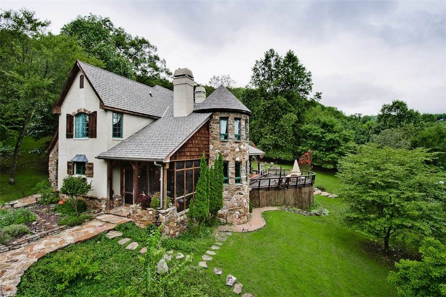 Stunning Beaver Lake home with luxurious finishes & gentle walk to private boat dock. Interior is a masterpiece of design & craftsmanship featuring: 3 fireplaces, 1860's hand hewn cabin beams, antique stained glass door, solid Western Pine slab bar & flooring, restaurant-style 6 burner gas range, sub zero refrigerator. Open living space flows to huge deck with amazing view of the lake & 5.72 acres. Solar-powered boat dock, terraced garden, orchard & stone walkways. Detached 2 car garage with bonus room.