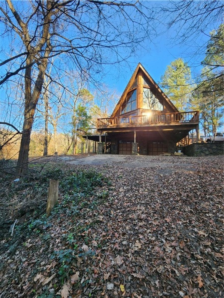 Welcome to this chalet-style home inspired by traditional Alpine architecture.Notice the steeply pitched
roof, extensive use of natural cedar wood siding and local stone work that create a rustic yet modern
retreat. This home blends traditional charm with contemporary features.Enjoy the warmth of the living
area by the central fireplace. The kitchen features granite countertops and new appliances.The open
floor plan is saturated with natural light from the floor to the soaring vaulted ceiling with a loft
overlooking the great room. The second floor boasts a large room over the carport that could be a
master suite, complete with its own private deck or make it into a recreational space.First floor
bedrooms are modest in size and have entrances from the outside, one has its own ensuite bathroom.
Bathrooms boast colorful vibes with sleek black fixtures. Ample storage throughout. Expansive decks.
Large workshop/garage/basement area. Desirable subdivision near golf course on semi private road.Minutes from town.