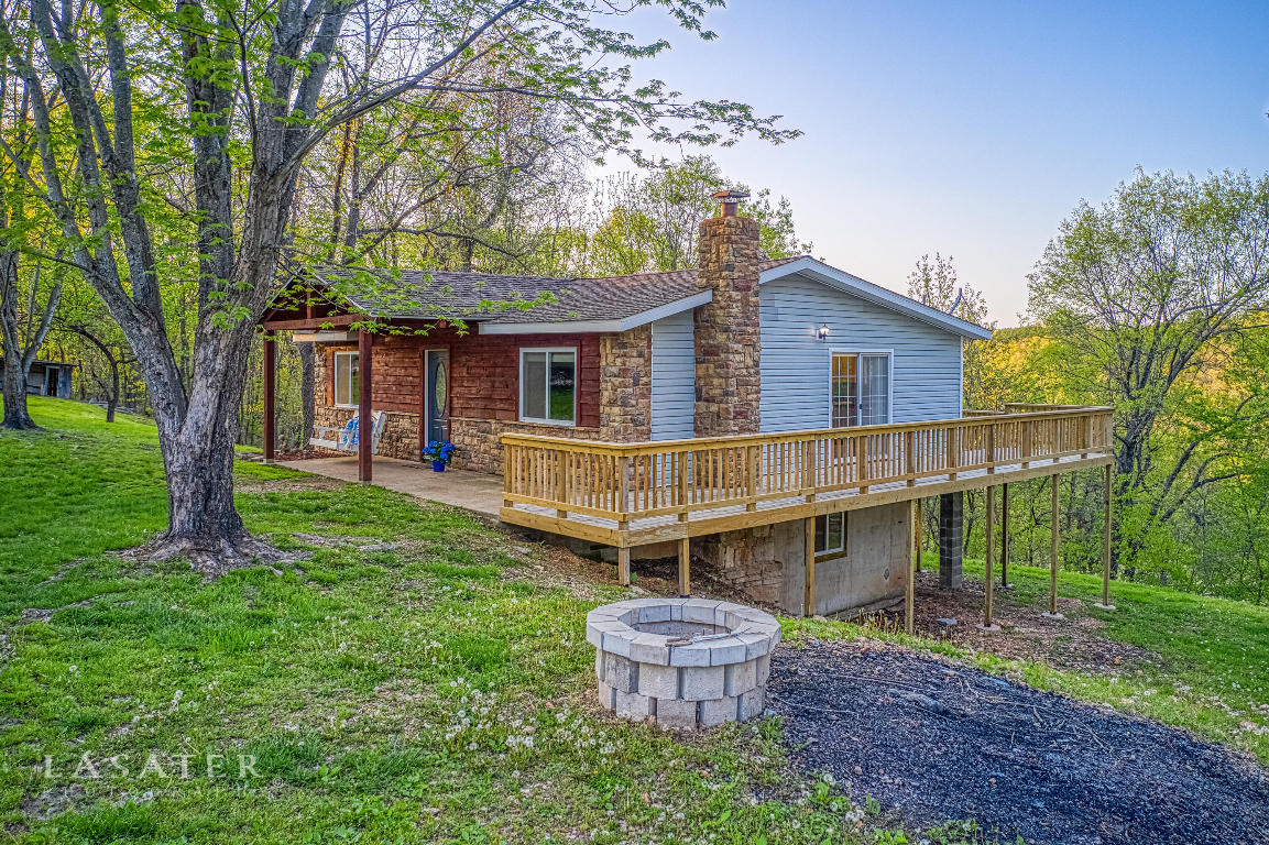 Perfect home, Perfect location! Check out this newly remodeled & move in ready home! This 3 BR, 3 Bath house sits on 6 acres & is nestled between Branson, MO & Harrison, AR! This home boasts an open floor plan & a LARGE walk around deck to enjoy a coffee or cocktail & some Ozarks seclusion at its best! You'll find very detailed work and special touches truly make this home one-of-a-kind! For example, in the guest bedroom upstairs lies a hidden closet BEHIND a book shelf with a ''sunken'' toy chest! Perfect to keep all your child's toys hidden away & adds a neat aura of mystery for the kids! Also, the basement has a walk-in vault with locking door for all your major valuables/collectibles! The double walkout basement sports 1BR/1BA & a wood fireplace to complete the country ambience!